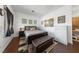 Cozy bedroom featuring natural light, modern decor, and a stylish leather storage bench at 4883 Grey Mesa St, Las Vegas, NV 89149