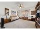 Cozy bedroom with ceiling fan, rattan furniture, a window and neutral carpet at 4883 Grey Mesa St, Las Vegas, NV 89149