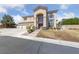 Charming two-story home featuring an arched entryway and a spacious three-car garage at 4883 Grey Mesa St, Las Vegas, NV 89149