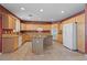 Spacious kitchen features an island, granite countertops, wooden cabinets, and stainless steel appliances at 4883 Grey Mesa St, Las Vegas, NV 89149