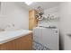Bright laundry room with front load washer and dryer, storage cabinet, sink and overhead shelf at 4883 Grey Mesa St, Las Vegas, NV 89149