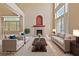 Bright living room with soaring ceilings, a cozy fireplace, and ample natural light at 4883 Grey Mesa St, Las Vegas, NV 89149