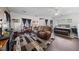 Spacious open concept living space and bedroom featuring dark wood floors, large rug and natural light at 4883 Grey Mesa St, Las Vegas, NV 89149