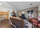 Spacious living space featuring a dining area, leather furniture and dark wood floors at 4883 Grey Mesa St, Las Vegas, NV 89149