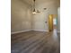 Open living room features modern lighting, a high ceiling, and a view of an open doorway at 5155 W Tropicana Ave # 2140, Las Vegas, NV 89103