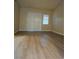 Living room with wood flooring and sliding doors leading to a balcony with natural light at 5155 W Tropicana Ave # 2140, Las Vegas, NV 89103