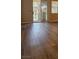 Living room with wood flooring, leading out to a private balcony with a wrought iron fence at 5155 W Tropicana Ave # 2140, Las Vegas, NV 89103