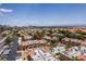 Areal view of condos highlighting the community pool, lush landscaping and skyline at 5166 S Jones Blvd # 205, Las Vegas, NV 89118