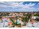 Aerial view showcases condos, pools, lush greenery, and distant mountain views at 5166 S Jones Blvd # 205, Las Vegas, NV 89118