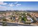 Expansive aerial view showcasing the community's layout with palm trees and a distant city skyline at 5166 S Jones Blvd # 205, Las Vegas, NV 89118