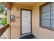 Inviting condo entrance showcasing a white front door, brown trim, and well-lit exterior with unit number 205 at 5166 S Jones Blvd # 205, Las Vegas, NV 89118