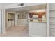 Open kitchen and laundry area featuring white appliances, dark wood cabinets, and granite countertops at 5166 S Jones Blvd # 205, Las Vegas, NV 89118