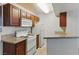 Efficient kitchen featuring white appliances, dark wood cabinets, and granite countertops at 5166 S Jones Blvd # 205, Las Vegas, NV 89118