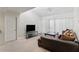 Bright living room featuring neutral walls and carpet, a large sofa, and a sliding glass door at 5166 S Jones Blvd # 205, Las Vegas, NV 89118