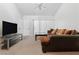 Inviting living room with neutral walls and carpet, ample lighting, and a large sofa at 5166 S Jones Blvd # 205, Las Vegas, NV 89118