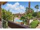 Relaxing condo community featuring a sparkling pool, mature palm trees, and well-maintained landscaping at 5166 S Jones Blvd # 205, Las Vegas, NV 89118