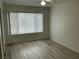 Inviting bedroom with new vinyl flooring, a large window, and ample natural light at 5222 Mandalay Springs Dr # 202, Las Vegas, NV 89120