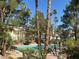 Inviting community pool surrounded by lush greenery and palm trees, perfect for relaxation at 5222 Mandalay Springs Dr # 202, Las Vegas, NV 89120
