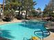 Clear blue community pool featuring umbrellas and lounging areas for relaxing afternoons at 5222 Mandalay Springs Dr # 202, Las Vegas, NV 89120