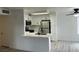 Open-concept kitchen featuring a breakfast bar, stainless steel appliances, and seamless flow to the living area at 5222 Mandalay Springs Dr # 202, Las Vegas, NV 89120