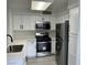 Well-equipped kitchen with stainless steel appliances, white cabinets, and a functional layout at 5222 Mandalay Springs Dr # 202, Las Vegas, NV 89120