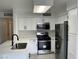 Modern kitchen boasts stainless steel appliances, white cabinets, and sleek countertops at 5222 Mandalay Springs Dr # 202, Las Vegas, NV 89120
