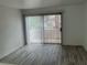 Bright living room featuring modern vinyl floors and a sliding glass door to a private patio at 5222 Mandalay Springs Dr # 202, Las Vegas, NV 89120