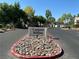Canyon Willow community entrance with lush landscaping and well-maintained street view under a clear blue sky at 5222 Mandalay Springs Dr # 202, Las Vegas, NV 89120