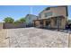 Large backyard with pavers, brick walls, and covered patio is ready for entertaining at 5966 Icicle Falls Ave, Las Vegas, NV 89130