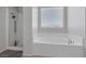 Bathroom featuring a glass shower and separate soaking tub with bright, natural lighting at 5966 Icicle Falls Ave, Las Vegas, NV 89130