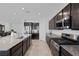 Kitchen features granite countertops, dark wood cabinets, and stainless appliances at 5966 Icicle Falls Ave, Las Vegas, NV 89130