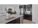 Modern kitchen featuring a large island with sink, stainless steel appliances, and dark cabinets at 5966 Icicle Falls Ave, Las Vegas, NV 89130