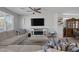 Comfortable living room with fireplace, TV, and large sectional couch at 5966 Icicle Falls Ave, Las Vegas, NV 89130