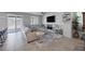 Spacious living room with a large sectional couch and modern TV console at 5966 Icicle Falls Ave, Las Vegas, NV 89130