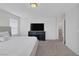 Spacious main bedroom features a large television, soft carpet, and neutral decor at 5966 Icicle Falls Ave, Las Vegas, NV 89130