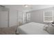 Bright main bedroom with two windows, ensuite bathroom, and neutral color palette at 5966 Icicle Falls Ave, Las Vegas, NV 89130