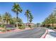 Lush landscaping surrounds the street leading to Mosaic Falls, showcasing a welcoming entrance at 5966 Icicle Falls Ave, Las Vegas, NV 89130