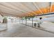 Covered back patio with concrete flooring overlooks backyard pool area and landscaping at 601 Huntington St, Las Vegas, NV 89107