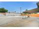Spacious backyard featuring a covered patio, an empty pool, and block wall fencing at 601 Huntington St, Las Vegas, NV 89107