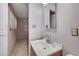 Close-up of bathroom sink, mirror and view into a secondary room at 601 Huntington St, Las Vegas, NV 89107