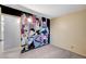 Unique bedroom with a colorful mural, carpeted floor, and bright lighting at 601 Huntington St, Las Vegas, NV 89107