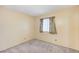 Cozy bedroom with a window, curtains, neutral carpet, and painted walls at 601 Huntington St, Las Vegas, NV 89107