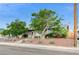 Front view of a single-story home, featuring desert landscaping and a chain-link fence at 601 Huntington St, Las Vegas, NV 89107