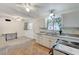 Bright kitchen features white cabinets, tile flooring, and an adjacent carpeted area at 601 Huntington St, Las Vegas, NV 89107
