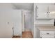 Bright kitchen includes white cabinets, tiled floor, and hallway access at 601 Huntington St, Las Vegas, NV 89107