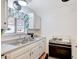 Bright kitchen featuring white cabinets and a stainless steel sink at 601 Huntington St, Las Vegas, NV 89107