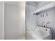 Bright laundry room with a white washing machine, convenient storage, and clothespins hanging on a line at 601 Huntington St, Las Vegas, NV 89107