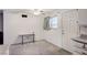 Bright living room includes carpeted floors, a window and a white door at 601 Huntington St, Las Vegas, NV 89107
