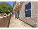 View of backyard patio, stucco wall, and sliding glass door to the home at 6117 Daisy Lee Ave, Las Vegas, NV 89108