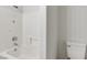 Bright bathroom featuring a shower over tub and white tiled walls at 6117 Daisy Lee Ave, Las Vegas, NV 89108